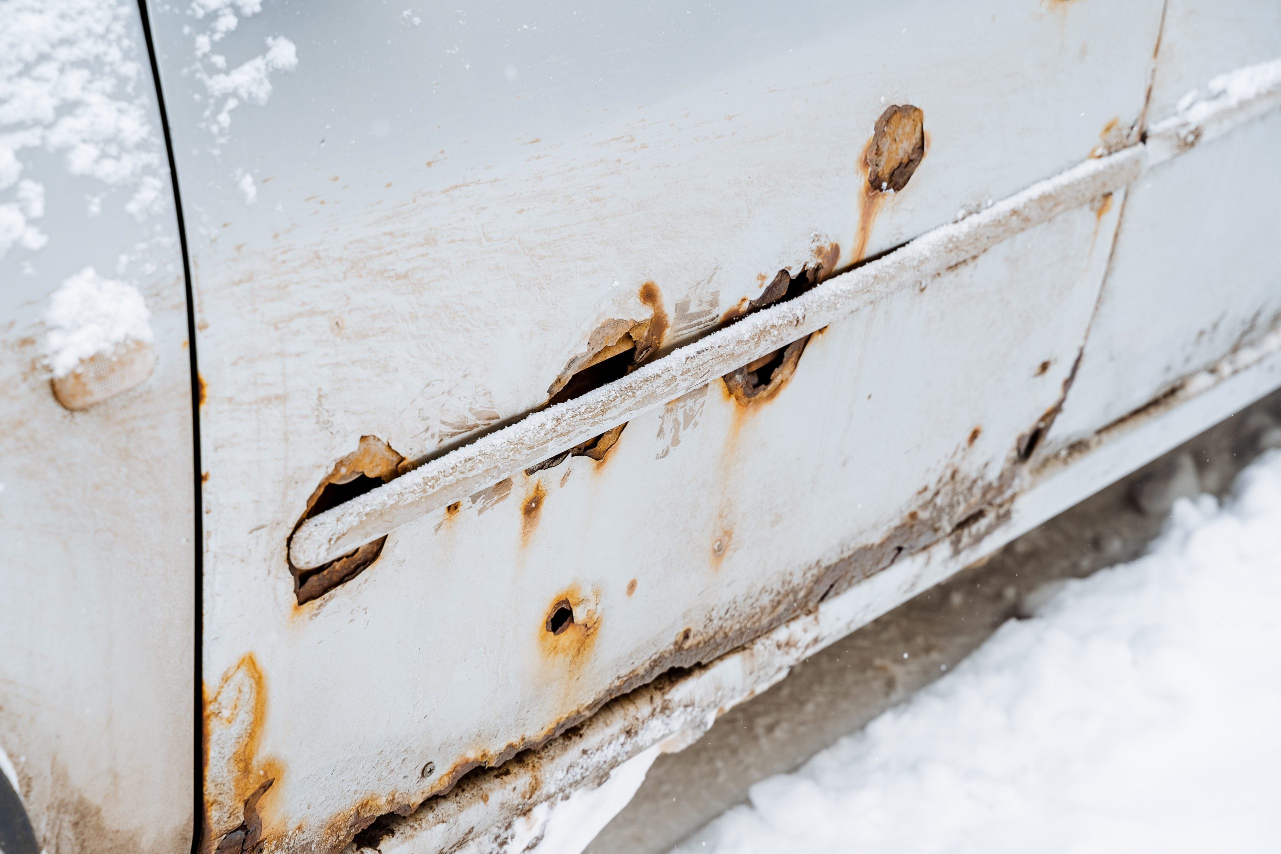 Rusted car sitting in snow